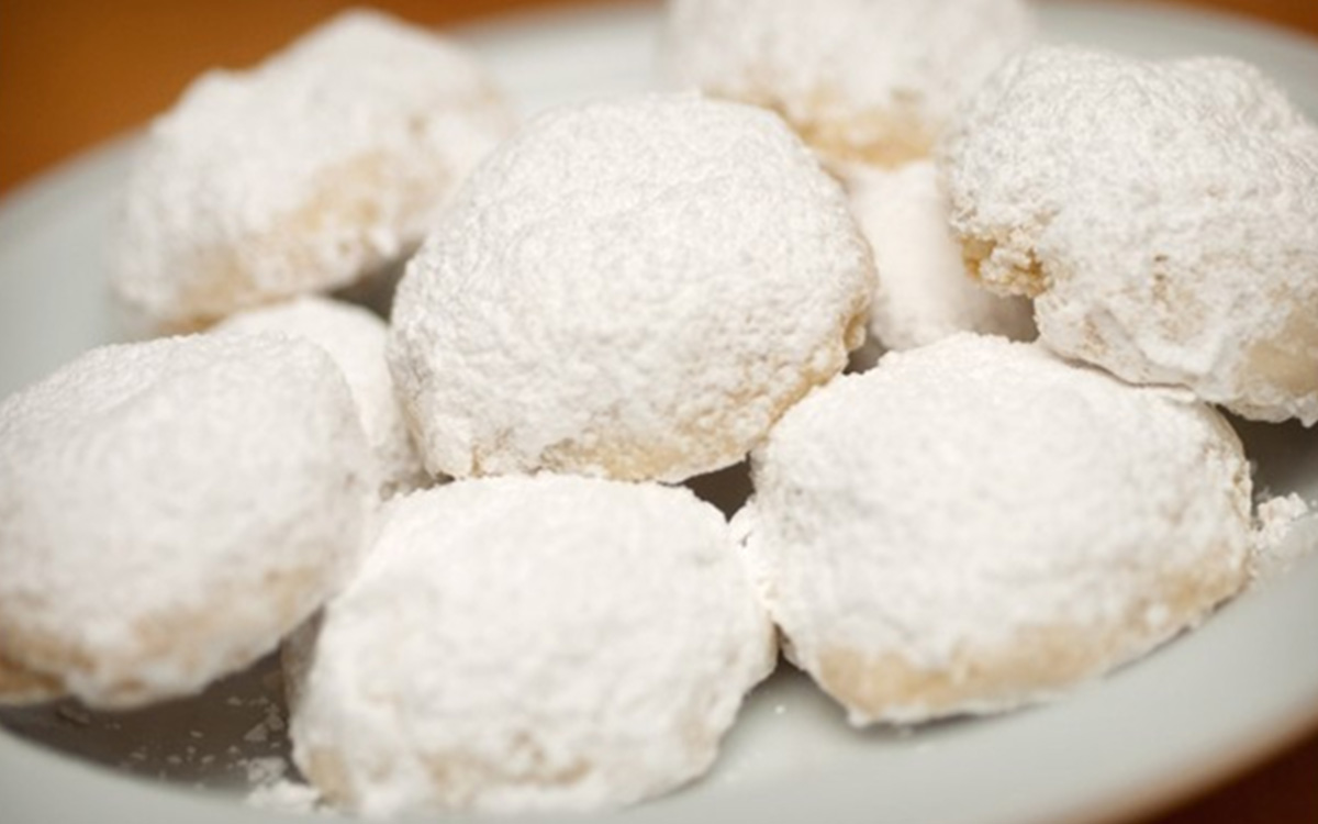 Our Kourambiethes are a delightful mouthful. Traditionally made for weddings, these little butter cookies are covered in powdered sugar.